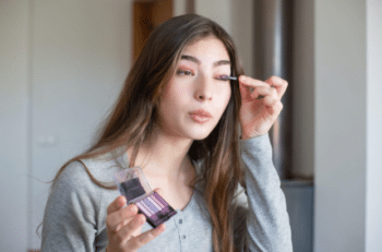 An influencer applying makeup could be used as whitelisted social media content for a brand partner