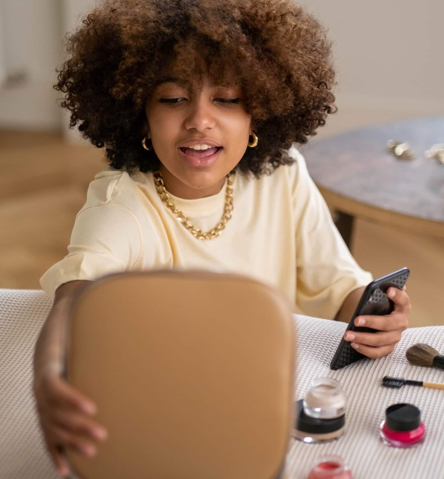 a woman filming herself putting on makeup to become a brand ambassador for beauty companies