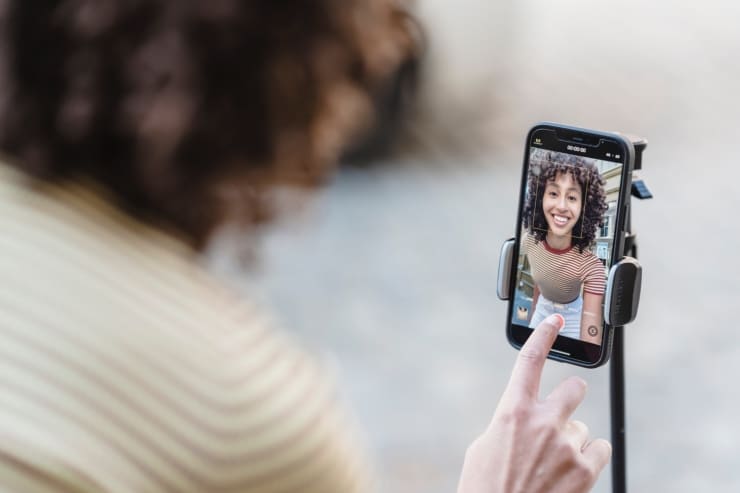 What is Snapchat Plus? A woman filming a video to upload to Snapchat Plus