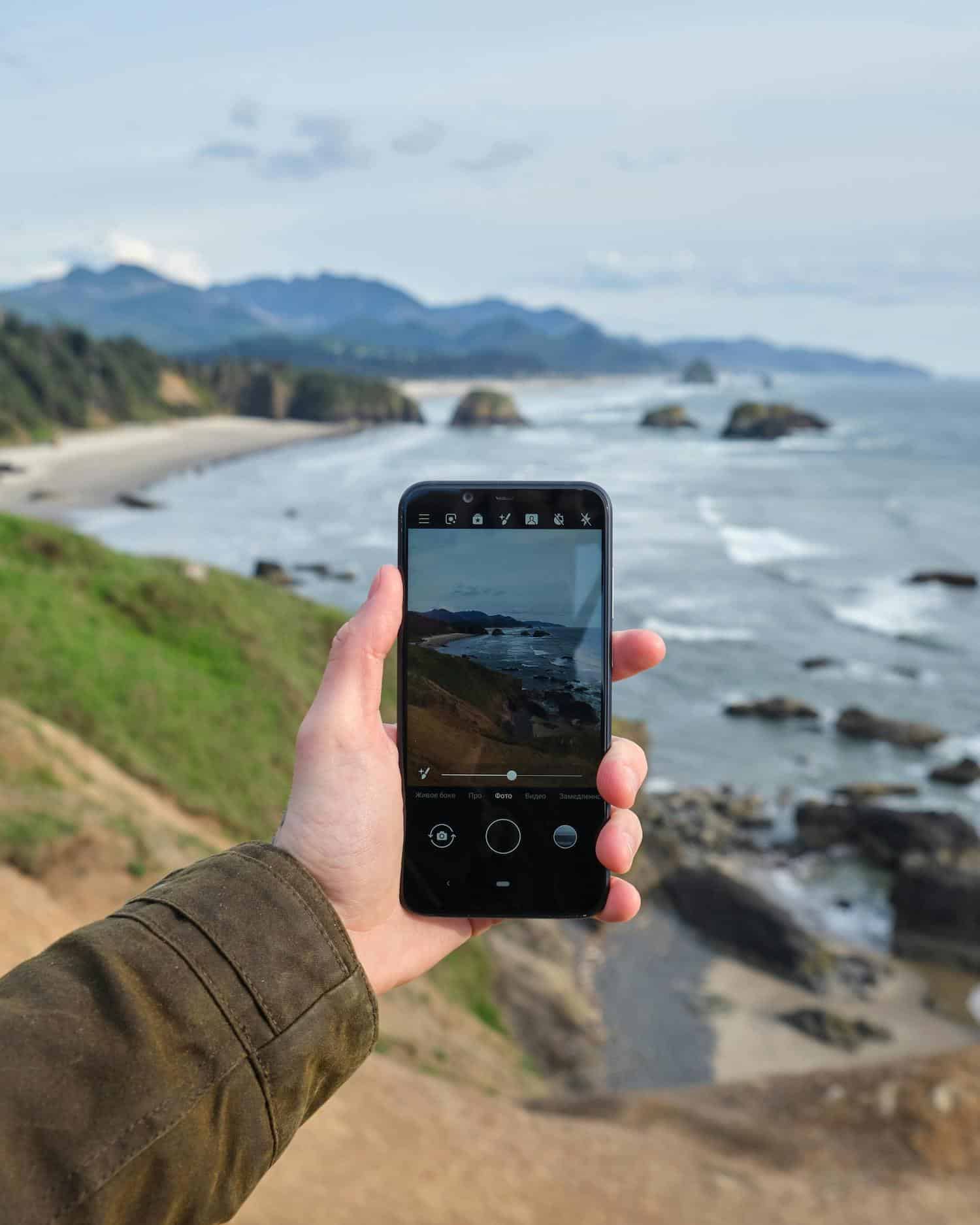 A person taking videos on their phone to use hyperlocal social media marketing.