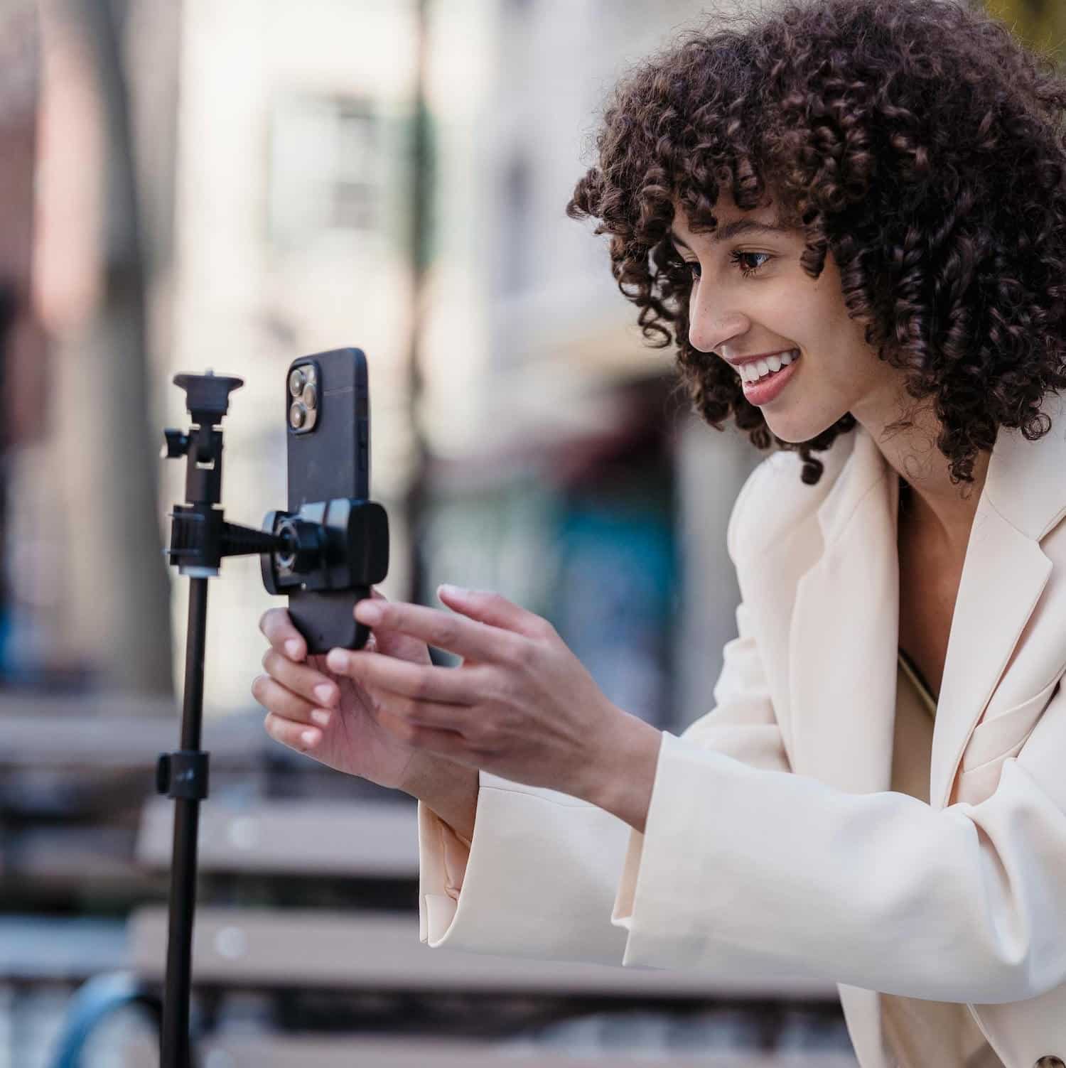 A creator filming a video outside to engage in hyperlocal social media marketing.