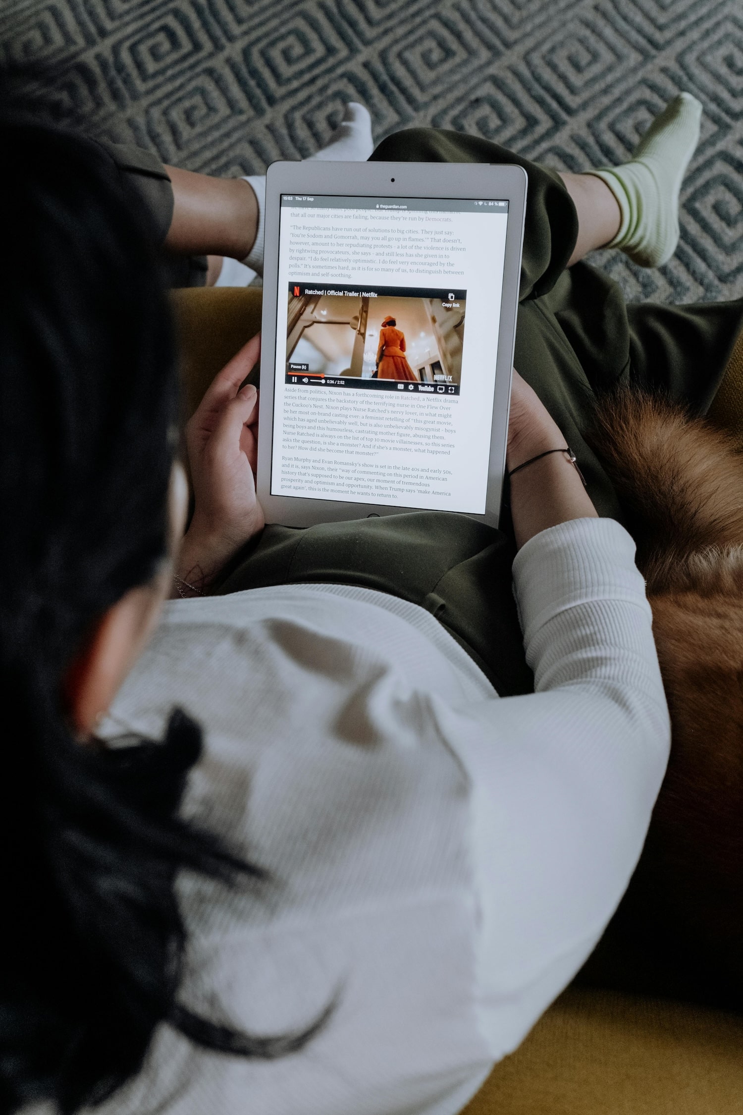 A person reading a newsletter on her tablet.