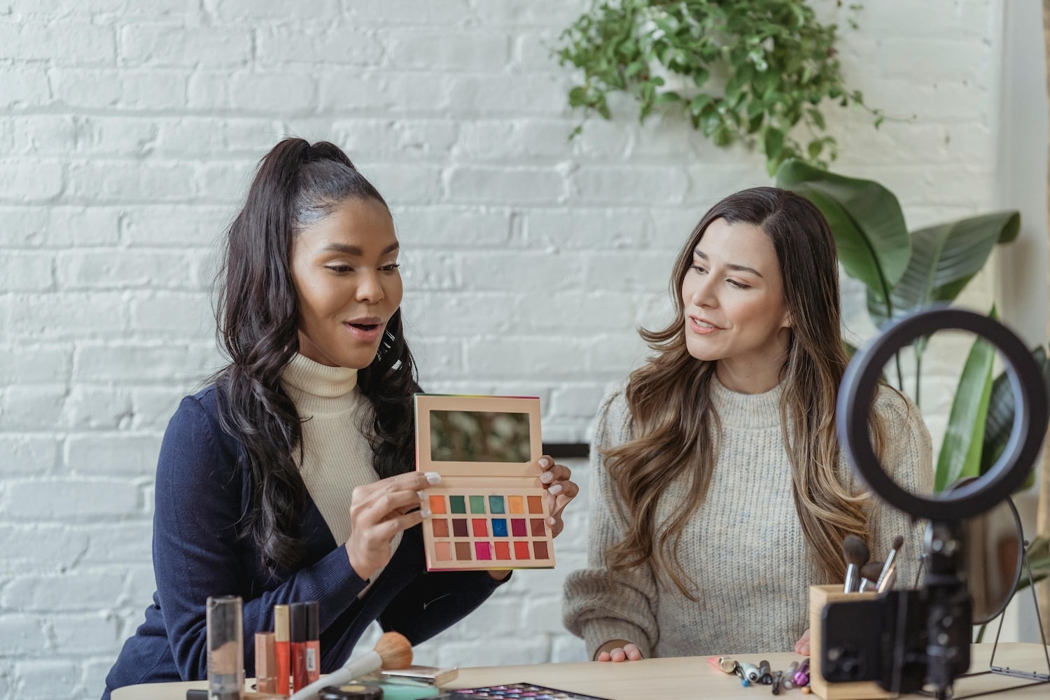 Two influencers filming a video to get followers on Pinterest.